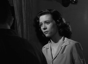Movie still from “The Best Years of Our Lives” (1946), directed by William Wyler – An old photo of a woman looking at the camera; Close Up shot, Over the shoulder angle