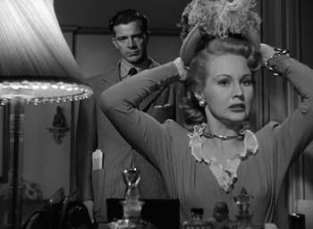 Movie still from “The Best Years of Our Lives” (1946), directed by William Wyler – A man and a woman in front of a mirror; Medium shot, Over the shoulder angle