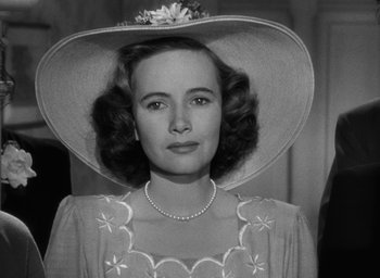 Movie still from “The Best Years of Our Lives” (1946), directed by William Wyler – A woman wearing a hat and a necklace; Close Up shot, Low angle