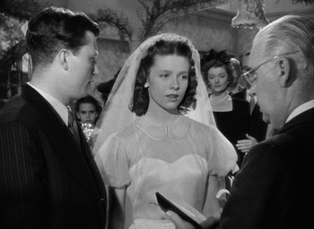 Movie still from “The Best Years of Our Lives” (1946), directed by William Wyler – An old photo of a woman getting married; Medium shot, Over the shoulder angle