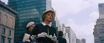 Movie still from “The Best of Everything” (1959), directed by Jean Negulesco – A woman wearing a hat and gloves on a city street; Medium shot, Low angle