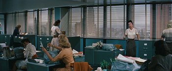 Movie still from “The Best of Everything” (1959), directed by Jean Negulesco – Two women are sitting at a desk in an office setting; Wide shot, Low angle
