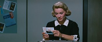 Movie still from “The Best of Everything” (1959), directed by Jean Negulesco – A woman is looking at a picture of a man; Close Up shot, Low angle