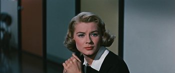 Movie still from “The Best of Everything” (1959), directed by Jean Negulesco – A person wearing a suit and tie; Close Up shot, Low angle
