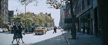 Movie still from “The Best of Everything” (1959), directed by Jean Negulesco – A man walking down the street in a city; Extreme Wide shot, High angle