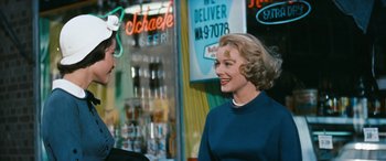 Movie still from “The Best of Everything” (1959), directed by Jean Negulesco – A woman in a blue sweater talking to a man in a blue shirt; Medium shot, Over the shoulder angle