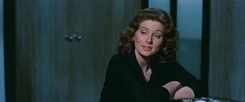 Movie still from “The Best of Everything” (1959), directed by Jean Negulesco – A person sitting in a room; Close Up shot, Over the shoulder angle