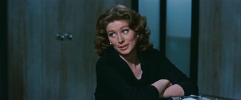 Movie still from “The Best of Everything” (1959), directed by Jean Negulesco – A person sitting in a room; Close Up shot, Over the shoulder angle