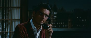 Movie still from “The Best of Everything” (1959), directed by Jean Negulesco – A man holding a phone up to his ear; Close Up shot, Over the shoulder angle