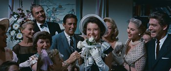 Movie still from “The Best of Everything” (1959), directed by Jean Negulesco – A man and a woman holding a bouquet of flowers; Close Up shot, Over the shoulder angle