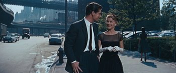 Movie still from “The Best of Everything” (1959), directed by Jean Negulesco – A man and a woman are standing on the sidewalk; Medium shot, Over the shoulder angle