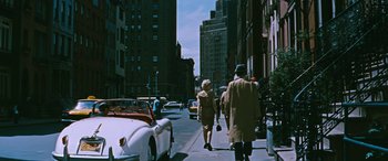 Movie still from “The Best of Everything” (1959), directed by Jean Negulesco – Two people walking down the sidewalk of a city street; Wide shot, High angle