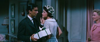 Movie still from “The Best of Everything” (1959), directed by Jean Negulesco – A man and a woman holding a gift box; Close Up shot, Over the shoulder angle