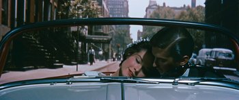 Movie still from “The Best of Everything” (1959), directed by Jean Negulesco – A man and a woman kissing in the back of a car; Close Up shot, High angle