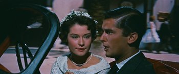 Movie still from “The Best of Everything” (1959), directed by Jean Negulesco – A man and a woman in formal wear looking at each other; Close Up shot, Over the shoulder angle