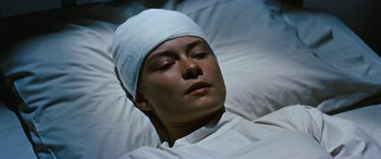 Movie still from “The Best of Everything” (1959), directed by Jean Negulesco – A woman with a head band laying in a bed; Close Up shot, High angle