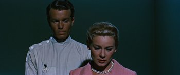 Movie still from “The Best of Everything” (1959), directed by Jean Negulesco – A man and a woman standing next to each other; Close Up shot, Low angle