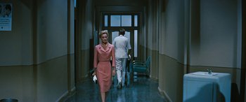Movie still from “The Best of Everything” (1959), directed by Jean Negulesco – A man and woman walking down a hall way; Wide shot, Over the shoulder angle