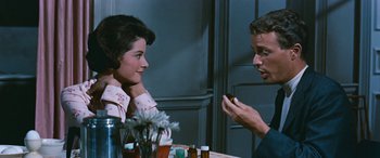 Movie still from “The Best of Everything” (1959), directed by Jean Negulesco – A man and a woman sitting at a dinner table; Close Up shot, Over the shoulder angle