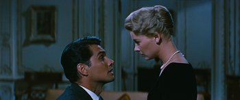 Movie still from “The Best of Everything” (1959), directed by Jean Negulesco – A man and a woman looking at one another; Close Up shot, Low angle
