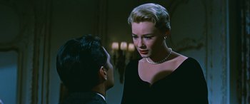 Movie still from “The Best of Everything” (1959), directed by Jean Negulesco – A man and a woman talking in front of candles; Close Up shot, Over the shoulder angle