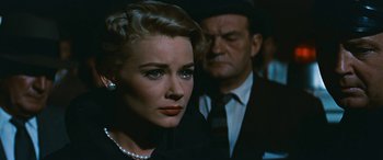 Movie still from “The Best of Everything” (1959), directed by Jean Negulesco – A man and a woman are standing next to each other; Close Up shot, Over the shoulder angle