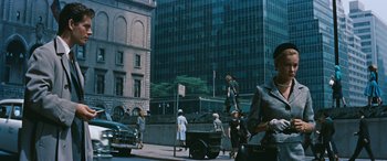 Movie still from “The Best of Everything” (1959), directed by Jean Negulesco – A group of people walking down a street near tall buildings; Wide shot, Low angle