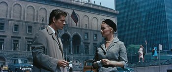 Movie still from “The Best of Everything” (1959), directed by Jean Negulesco – A man and a woman standing next to each other on the street; Medium shot, Over the shoulder angle