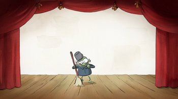 Movie still from “The Big Bad Fox and Other Tales” (2017), directed by Patrick Imbert – A cartoon of a frog holding a broom on a stage; Wide shot, High angle