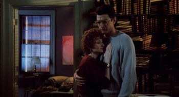 Movie still from “The Big Chill” (1983), directed by Lawrence Kasdan – A man and a woman standing next to each other in a room; Medium shot, Low angle
