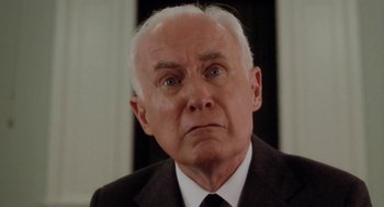 Movie still from “The Big Chill” (1983), directed by Lawrence Kasdan – An older man wearing a suit and tie; Close Up shot, Low angle