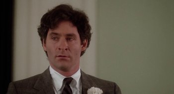 Movie still from “The Big Chill” (1983), directed by Lawrence Kasdan – A man in a suit and tie; Close Up shot, Over the shoulder angle