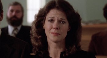 Movie still from “The Big Chill” (1983), directed by Lawrence Kasdan – A person with curly hair; Close Up shot, Over the shoulder angle