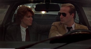 Movie still from “The Big Chill” (1983), directed by Lawrence Kasdan – A man and a woman sitting in the back of a car; Close Up shot, Low angle