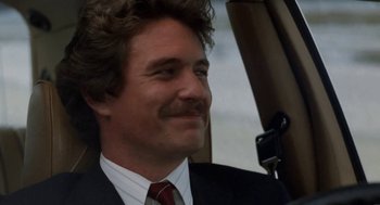 Movie still from “The Big Chill” (1983), directed by Lawrence Kasdan – A person wearing a suit and tie; Close Up shot, Low angle