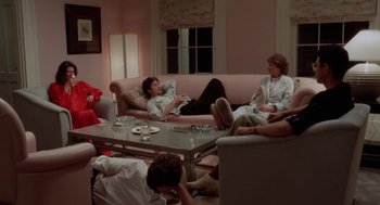 Movie still from “The Big Chill” (1983), directed by Lawrence Kasdan – A group of people sitting around a living room table; Wide shot, High angle