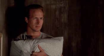 Movie still from “The Big Chill” (1983), directed by Lawrence Kasdan – A man holding a pillow in his hands; Close Up shot, Low angle