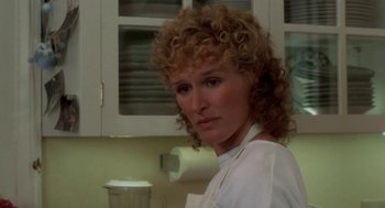 Movie still from “The Big Chill” (1983), directed by Lawrence Kasdan – A person with a cup in a room; Close Up shot, Over the shoulder angle