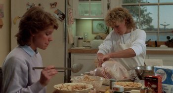 Movie still from “The Big Chill” (1983), directed by Lawrence Kasdan – Two women preparing a turkey for thanksgiving dinner; Medium shot, Low angle