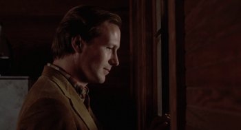 Movie still from “The Big Chill” (1983), directed by Lawrence Kasdan – A person standing near a window; Close Up shot, Low angle