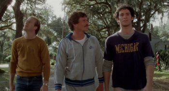 Movie still from “The Big Chill” (1983), directed by Lawrence Kasdan – A group of men standing next to each other on a sidewalk; Medium shot, Low angle