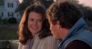 Movie still from “The Big Chill” (1983), directed by Lawrence Kasdan – A man and a woman smiling at each other; Close Up shot, Over the shoulder angle