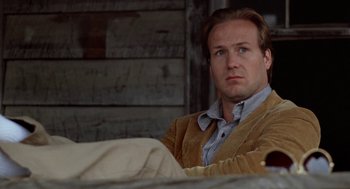 Movie still from “The Big Chill” (1983), directed by Lawrence Kasdan – A person sitting on a couch; Close Up shot, Low angle