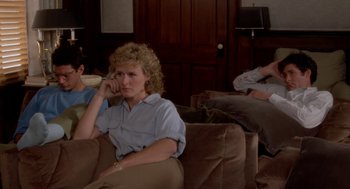 Movie still from “The Big Chill” (1983), directed by Lawrence Kasdan – A woman sitting on a couch while talking on the phone; Medium shot, High angle
