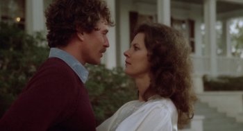 Movie still from “The Big Chill” (1983), directed by Lawrence Kasdan – A man and a woman standing next to each other in front of a house; Close Up shot, Low angle