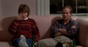 Movie still from “The Big Chill” (1983), directed by Lawrence Kasdan – A man and a woman sitting on a pink couch; Medium shot, Low angle
