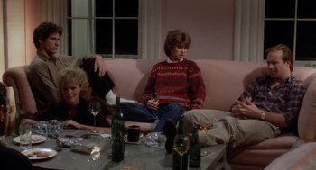 Movie still from “The Big Chill” (1983), directed by Lawrence Kasdan – A group of people sitting around a table with wine glasses; Medium shot, High angle