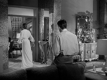 Movie still from “The Big Heat” (1953), directed by Fritz Lang – A man and a woman standing in front of a mirror; Wide shot, Over the shoulder angle