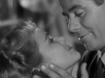 Movie still from “The Big Heat” (1953), directed by Fritz Lang – A man and a woman are looking into each others eyes; Close Up shot, Low angle