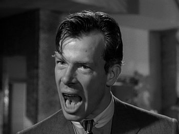 Movie still from “The Big Heat” (1953), directed by Fritz Lang – A man in a suit and tie with his mouth wide open; Close Up shot, Low angle